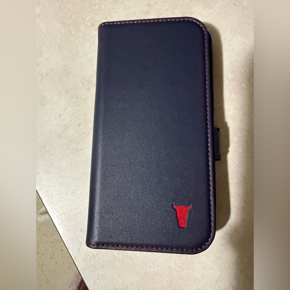 Toro Blue Leather Phone Wallet with Red Logo for iPhone 15 pro.